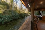 Enjoy the covered deck hanging over the river